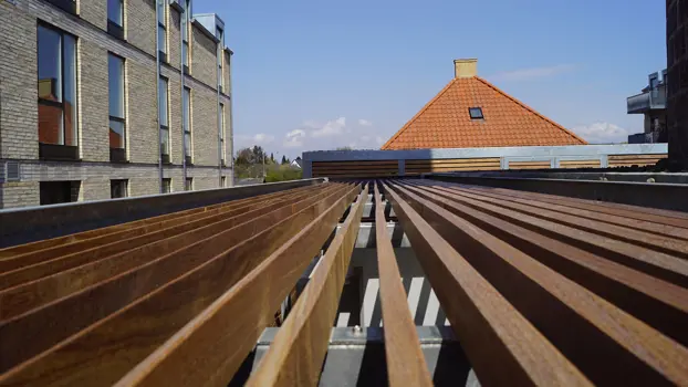 Mülleinhausung mit horizontaler Lamellenverkleidung aus Cumaru-Holz